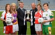 15 July 2013; Pictured at the launch are Pol O Gallchoir, Ceannsaí TG4, and Pat Quill, Pat Quill, President of the Ladies Football Association, with junior players, from left to right, Ashelene Groogan, Kellie Kearney, Wexford, Grace Lynch, Louth, and Siobhan Flannery, Offaly. September 29th will be the 40th time that the final of the Senior Ladies Gaelic Football Final will be contested. The first final took place in October 1974 and was contested by Tipperary and Offaly in a game that was won by the Tipperary women. The most successful team in the history of the game are Kerry who have won the title on 11 occasions including an unprecedented 9-in-a-row. In recent years Cork have been the dominant force winning 7 of the last 8 titles. TG4 made the announcement that RefCam will be introduced to Irish Sport for the first time. The lightweight head mounted device will be a feature of TG4’s live coverage of the 2013 Ladies Football Championship and will provide viewers with unique insight into the game but it will also be a hugely valuable coaching resource for referees. 2013 TG4 All-Ireland Ladies Football Championship Launch, Croke Park, Dublin. Picture credit: David Maher / SPORTSFILE