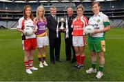 15 July 2013; Pictured at the launch are Pol O Gallchoir, Ceannsaí TG4, and Pat Quill, Pat Quill, President of the Ladies Football Association, with junior players, from left to right, Ashelene Groogan, Kellie Kearney, Wexford, Grace Lynch, Louth, and Siobhan Flannery, Offaly. September 29th will be the 40th time that the final of the Senior Ladies Gaelic Football Final will be contested. The first final took place in October 1974 and was contested by Tipperary and Offaly in a game that was won by the Tipperary women. The most successful team in the history of the game are Kerry who have won the title on 11 occasions including an unprecedented 9-in-a-row. In recent years Cork have been the dominant force winning 7 of the last 8 titles. TG4 made the announcement that RefCam will be introduced to Irish Sport for the first time. The lightweight head mounted device will be a feature of TG4’s live coverage of the 2013 Ladies Football Championship and will provide viewers with unique insight into the game but it will also be a hugely valuable coaching resource for referees. 2013 TG4 All-Ireland Ladies Football Championship Launch, Croke Park, Dublin. Picture credit: David Maher / SPORTSFILE