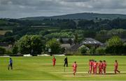 25 June 2021; Munster Reds players celebrate as Kevin O'Brien of Leinster Lightning walks during the Cricket Ireland InterProvincial Trophy 2021 match between Leinster Lightning and Munster Reds at Bready Cricket Club in Magheramason, Tyrone. Photo by Harry Murphy/Sportsfile