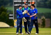 26 June 2021; North West Warriors players, from left, Stephen Doheny, Shane Getkate and Ryan Macbeth embrace at the end of the innings during the Cricket Ireland InterProvincial Trophy 2021 match between North West Warriors and Munster Reds at Bready Cricket Club in Magheramason, Tyrone. Photo by Harry Murphy/Sportsfile