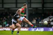 26 June 2021; Aidan O'Shea of Mayo shoots to score his side's first goal despite the attempted tackle from Paul McNamara of Sligo during the Connacht GAA Football Senior Championship Quarter-Final match between Sligo and Mayo at Markievicz Park in Sligo. Photo by David Fitzgerald/Sportsfile