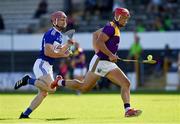 26 June 2021; Lee Chin of Wexford in action against Ciaran Collier of Laois during the Leinster GAA Hurling Senior Championship Quarter-Final match between Wexford and Laois at UPMC Nowlan Park in Kilkenny. Photo by Ray McManus/Sportsfile