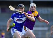 26 June 2021; PJ Scully of Laois in action against Liam Ryan of Wexford during the Leinster GAA Hurling Senior Championship Quarter-Final match between Wexford and Laois at UPMC Nowlan Park in Kilkenny. Photo by Ray McManus/Sportsfile