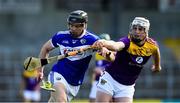 26 June 2021; PJ Scully of Laois in action against Liam Ryan of Wexford during the Leinster GAA Hurling Senior Championship Quarter-Final match between Wexford and Laois at UPMC Nowlan Park in Kilkenny. Photo by Ray McManus/Sportsfile