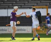 26 June 2021; Cathal Dunbar of Wexford greets Laois goalkeeper Enda Rowland after the Leinster GAA Hurling Senior Championship Quarter-Final match between Wexford and Laois at UPMC Nowlan Park in Kilkenny. Photo by Ray McManus/Sportsfile