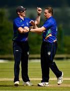 27 June 2021; Graham Hume of North West Warriors, right, celebrates with team-mate Craig Young after taking the wicket of Kevin O'Brien of Leinster Lightning during the Cricket Ireland InterProvincial Trophy 2021 match between North West Warriors and Leinster Lightning at Bready Cricket Club in Magheramason, Tyrone. Photo by Harry Murphy/Sportsfile