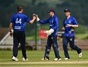 27 June 2021; Craig Young of North West Warriors, left, celebrates bowling out Barry McCarthy of Leinster Lightning with team-mates Stephen Doheny and Ryan Macbeth during the Cricket Ireland InterProvincial Trophy 2021 match between North West Warriors and Leinster Lightning at Bready Cricket Club in Magheramason, Tyrone. Photo by Harry Murphy/Sportsfile