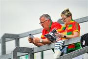 27 June 2021; Carlow supporters review the match day programme before the Leinster GAA Football Senior Championship Round 1 match between Carlow and Longford at Bord Na Mona O’Connor Park in Tullamore, Offaly. Photo by Eóin Noonan/Sportsfile