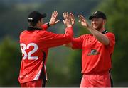27 June 2021; Greg Ford, left, and Aaron Cawley of Munster Reds celebrate the wicket of James McCollum of Northern Knights during the Cricket Ireland InterProvincial Trophy 2021 match between Northern Knights and Munster Reds at Bready Cricket Club in Magheramason, Tyrone. Photo by Harry Murphy/Sportsfile