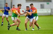 27 June 2021; Donal McElligott of Longford is tackled by Conor Crowley, left, and Colm Hulton of Carlow during the Leinster GAA Football Senior Championship Round 1 match between Carlow and Longford at Bord Na Mona O’Connor Park in Tullamore, Offaly. Photo by Eóin Noonan/Sportsfile