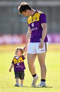 27 June 2021; Benji Brosnan, age 18 months, with his father, Wexford footballer Ben Brosnan, on the pitch after the Leinster GAA Football Senior Championship Round 1 match between Wicklow and Wexford at County Grounds in Aughrim, Wicklow. Photo by Piaras Ó Mídheach/Sportsfile