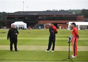 30 June 2021; Referee Phil Thompson tosses the coin watched by team captains Harry Tector of Northern Knights and PJ Moor of Miunster Reds prior to the Cricket Ireland InterProvincial Cup 2021 match between Northern Knights and Munster Reds at Bready Cricket Club in Stormont in Belfast. Photo by David Fitzgerald/Sportsfile