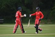 30 June 2021; PJ Moor, left, and Murray Cummins of Munster Reds fist bump during the Cricket Ireland InterProvincial Cup 2021 match between Northern Knights and Munster Reds at Bready Cricket Club in Stormont in Belfast. Photo by David Fitzgerald/Sportsfile