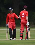 30 June 2021; Murray Cummins, left, and Jack Carty of Munster Reds fist bump during the Cricket Ireland InterProvincial Cup 2021 match between Northern Knights and Munster Reds at Bready Cricket Club in Stormont in Belfast. Photo by David Fitzgerald/Sportsfile