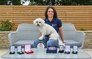 1 July 2021; Noelle Healy pictured at home with her dog Luna and some stand-out medals and awards from her career. Noelle was helping to launch the Bord Gáis Energy GAA Legends Tour Series for 2021. The tours start online on Wednesday, 7 July continuing weekly for eight weeks, and can be viewed on Bord Gáis Energy Rewards page - bordgaisenergy.ie/my-rewards. Photo by Brendan Moran/Sportsfile