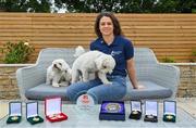 1 July 2021; Noelle Healy pictured at home with her dogs Luna, left, and Rory and some stand-out medals and awards from her career. Noelle was helping to launch the Bord Gáis Energy GAA Legends Tour Series for 2021. The tours start online on Wednesday, 7 July continuing weekly for eight weeks, and can be viewed on Bord Gáis Energy Rewards page - bordgaisenergy.ie/my-rewards. Photo by Brendan Moran/Sportsfile