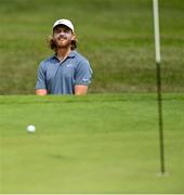 1 July 2021; Tommy Fleetwood of England reacts after chipping on to the first green from the bunker during day one of the Dubai Duty Free Irish Open Golf Championship at Mount Juliet Golf Club in Thomastown, Kilkenny. Photo by Ramsey Cardy/Sportsfile