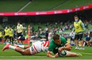 3 July 2021; Jacob Stockdale of Ireland dives over to score his side's fifth try despite the tackle of Semisi Masirewa of Japan during the International Rugby Friendly match between Ireland and Japan at the Aviva Stadium in Dublin. Photo by Harry Murphy/Sportsfile