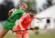 3 July 2021; Amy O'Connor of Cork in action against Muireann Creamer of Limerick during the Munster Senior Camogie Final match between Cork and Limerick at Drom & Inch GAA in Tipperary.  Photo by Matt Browne/Sportsfile
