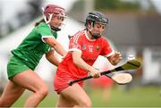 3 July 2021; Amy O'Connor of Cork in action against Muireann Creamer of Limerick during the Munster Senior Camogie Final match between Cork and Limerick at Drom & Inch GAA in Tipperary.  Photo by Matt Browne/Sportsfile
