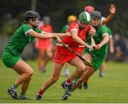 3 July 2021; Hannah Looney of Cork in action against Niamh Ryan and Judith Mulcahy of Limerick during the Munster Senior Camogie Final match between Cork and Limerick at Drom & Inch GAA in Tipperary.  Photo by Matt Browne/Sportsfile