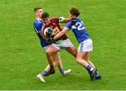 4 July 2021; Denis Corroon of Westmeath is tackled by Evan Carroll, left, and Finbar Crowley of Laois during the Leinster GAA Football Senior Championship Quarter-Final match between Laois and Westmeath at Bord Na Mona O'Connor Park in Tullamore, Offaly. Photo by Eóin Noonan/Sportsfile