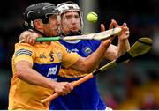 4 July 2021; David Reidy of Clare in action against Brendan Maher of Tipperary during the Munster GAA Hurling Senior Championship Semi-Final match between Tipperary and Clare at LIT Gaelic Grounds in Limerick. Photo by Ray McManus/Sportsfile