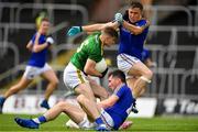 4 July 2021; Cathal Hickey of Meath holds off the challenge of Longford's Enda Macken and Daniel Mimnagh on his way to scoring his side's third goal during the Leinster GAA Football Senior Championship Quarter-Final match between Meath and Longford at Páirc Tailteann in Navan, Meath. Photo by Seb Daly/Sportsfile