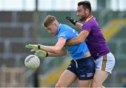 4 July 2021; Peadar Ó Cofaigh Byrne of Dublin is tackled by Daithí Waters of Wexford during the Leinster GAA Football Senior Championship Quarter-Final match between Wexford and Dublin at Chadwicks Wexford Park in Wexford. Photo by Brendan Moran/Sportsfile