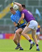 4 July 2021; Peadar Ó Cofaigh Byrne of Dublin is tackled by Daithí Waters of Wexford during the Leinster GAA Football Senior Championship Quarter-Final match between Wexford and Dublin at Chadwicks Wexford Park in Wexford. Photo by Brendan Moran/Sportsfile