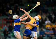 4 July 2021; Aron Shanagher of Clare in action against Padraic Maher, left, and Barry Heffernan of Tipperary during the Munster GAA Hurling Senior Championship Semi-Final match between Tipperary and Clare at LIT Gaelic Grounds in Limerick. Photo by Stephen McCarthy/Sportsfile