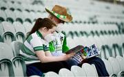 10 July 2021; Isabelle Hurley, aged 11, from Castlemahon, Limerick, reads the match programme with her grandfather Patrick Sexton before the Munster GAA Football Senior Championship Semi-Final match between Limerick and Cork at the LIT Gaelic Grounds in Limerick. Photo by Harry Murphy/Sportsfile