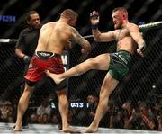 10 July 2021; Conor McGregor, right, and Dustin Poirier in their lightweight fight during the UFC 264 event at T-Mobile Arena in Las Vegas, Nevada, USA. Photo by Thomas King/Sportsfile