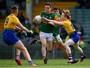 11 July 2021; Oisín Maunsell of Kerry in action against Aaron Shannon, right, and Jamesie Greene of Roscommon during the 2020 Electric Ireland GAA Football All-Ireland Minor Championship Semi-Final match between Roscommon and Kerry at LIT Gaelic Grounds in Limerick. Photo by Piaras Ó Mídheach/Sportsfile