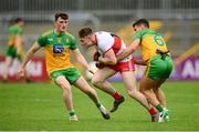 11 July 2021; Ethan Doherty of Derry in action against Odhran McFadden Ferry and Niall O'Donnell, left, of Donegal during the Ulster GAA Football Senior Championship Quarter-Final match between Derry and Donegal at Páirc MacCumhaill in Ballybofey, Donegal. Photo by Stephen McCarthy/Sportsfile