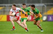 11 July 2021; Ethan Doherty of Derry in action against Odhran McFadden Ferry, right, and Niall O'Donnell of Donegal during the Ulster GAA Football Senior Championship Quarter-Final match between Derry and Donegal at Páirc MacCumhaill in Ballybofey, Donegal. Photo by Stephen McCarthy/Sportsfile