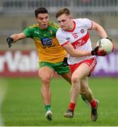 11 July 2021; Ethan Doherty of Derry in action against Odhran McFadden Ferry of Donegal during the Ulster GAA Football Senior Championship Quarter-Final match between Derry and Donegal at Páirc MacCumhaill in Ballybofey, Donegal. Photo by Stephen McCarthy/Sportsfile