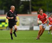 10 July 2021; Referee John Devlin keeps a close eye as Ciara O'Sullivan of Cork solos up the field during the TG4 All-Ireland Senior Ladies Football Championship Group 2 Round 1 match between Cork and Meath at St Brendan's Park in Birr, Offaly. Photo by Ray McManus/Sportsfile