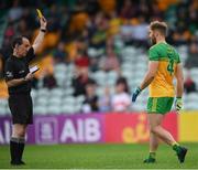 11 July 2021; Stephen McMenamin of Donegal is issued with a yellow card by referee David Coldrick before the start of the second half during the Ulster GAA Football Senior Championship Quarter-Final match between Derry and Donegal at Páirc MacCumhaill in Ballybofey, Donegal. Photo by Stephen McCarthy/Sportsfile