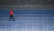 14 July 2021; A member of Semple Stadium ground staff sanitises seats in the O'Ríain stand before the 2021 Electric Ireland Munster GAA Hurling Minor Championship Quarter-Final match between Clare and Cork at Semple Stadium in Thurles, Tipperary. Photo by Eóin Noonan/Sportsfile