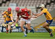 14 July 2021; Ben O’Connor of Cork is tackled by Colm Killeen, left, and Callum Hassett of Clare during the 2021 Electric Ireland Munster GAA Hurling Minor Championship Quarter-Final match between Clare and Cork at Semple Stadium in Thurles, Tipperary. Photo by Eóin Noonan/Sportsfile