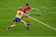 14 July 2021; Ross O’Sullivan of Cork scores his side's sixth goal despite the attention of John Cahill of Clare during the 2021 Electric Ireland Munster GAA Hurling Minor Championship Quarter-Final match between Clare and Cork at Semple Stadium in Thurles, Tipperary. Photo by Eóin Noonan/Sportsfile