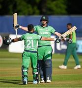 16 July 2021; Simi Singh of Ireland, left, is congratulated by team-mate Craig Young after bringing up his century during the 3rd Dafanews Cup Series One Day International match between Ireland and South Africa at The Village in Malahide, Dublin. Photo by Seb Daly/Sportsfile