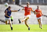 17 July 2021; Caroline O Hanlon of Armagh kicks a point despite the attention of Racheal Doonan of Cavan during the TG4 All-Ireland Senior Ladies Football Championship Group 2 Round 2 match between Armagh and Cavan at St Tiernach's Park in Monaghan. Photo by Ben McShane/Sportsfile