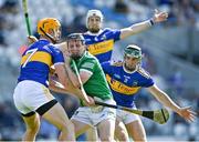 18 July 2021; Peter Casey of Limerick in action against Tipperary players, from left, Barry Heffernan, Brendan Maher and Cathal Barrett during the Munster GAA Hurling Senior Championship Final match between Limerick and Tipperary at Páirc Uí Chaoimh in Cork. Photo by Piaras Ó Mídheach/Sportsfile