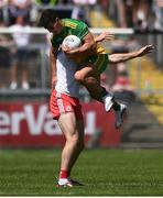18 July 2021; Odhran McFadden Ferry of Donegal is held by Brian Kennedy of Tyrone during the Ulster GAA Football Senior Championship Semi-Final match between Donegal and Tyrone at Brewster Park in Enniskillen, Fermanagh. Photo by Ben McShane/Sportsfile