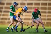 19 July 2021; Adam Mungovan of Clare in action against Bryan Nix, left, and Donnacha O'Dalaigh of Limerick during the Munster GAA Hurling U20 Championship semi-final match between Limerick and Clare at the LIT Gaelic Grounds in Limerick. Photo by Ben McShane/Sportsfile