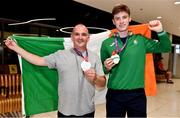 19 July 2021; Cian McPhillips of Ireland with coach Joe Ryan and his Men's 1500m gold medal at Dublin Airport as Team Ireland return home from the European U20 Athletics Championships. Photo by Sam Barnes/Sportsfile