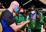 19 July 2021; Luke and Emily McHugh admire the gold medals won in the Women's 100m and 200m by Rhasidat Adeleke of Ireland at Dublin Airport as Team Ireland return home from the European U20 Athletics Championships. Photo by Sam Barnes/Sportsfile