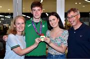 19 July 2021; Cian McPhillips of Ireland with his parents Laura and Paddy and sister Sarah and his Men's 1500m gold medal at Dublin Airport as Team Ireland return home from the European U20 Athletics Championships. Photo by Sam Barnes/SPORTSFILE